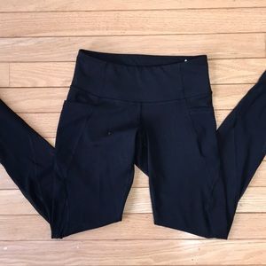 Black athletic leggings with pockets. Never worn.
